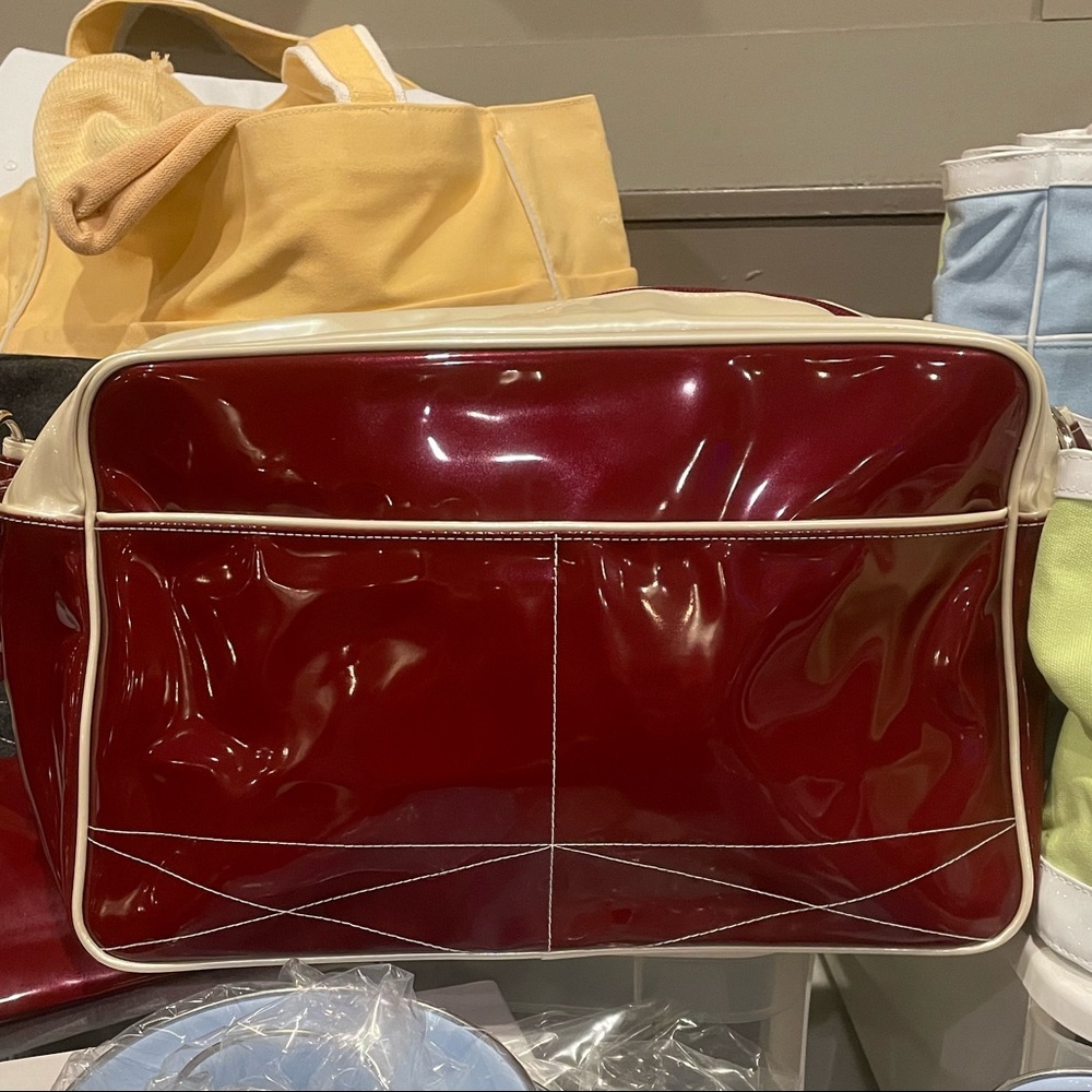 SWEET TULIP travel tote in maroon and cream patent
vinyl.